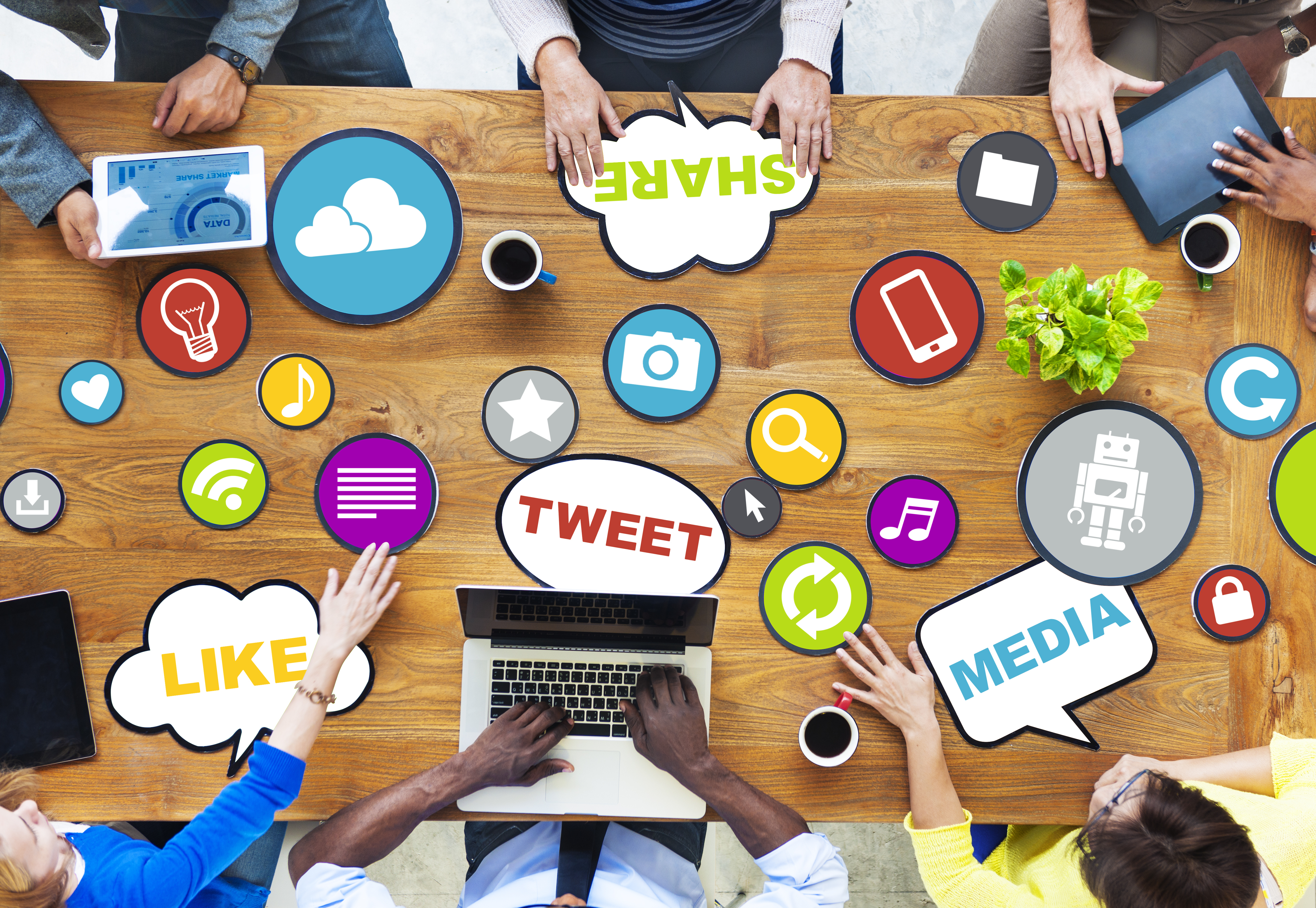 a meeting table with several people discussing social media related topics